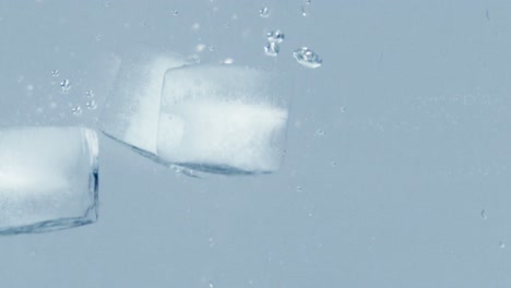 ice cubes are thrown into the water, after a while they come back to the surface