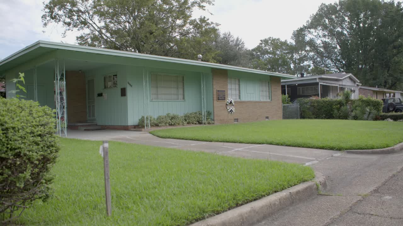 Rack focus from street: Civil rights leader Medgar Evers home. Site of his assassination. Jackson, Mississippi.