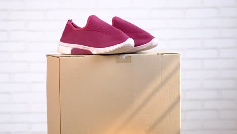 pink shoes on a cardboard box