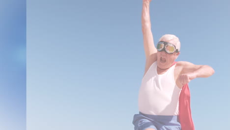 animation of clouds over senior caucasian man wearing superhero costume on beach