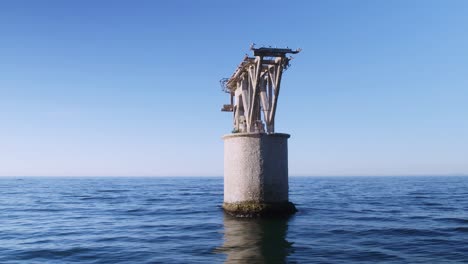 abandoned structure in the middle of the mediterranean sea near the coastline of marbella, spain