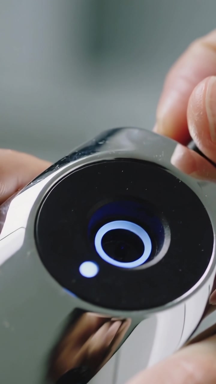 Vertical video: Securing ringed device connector, fingers entering top-right gently adjusting cable