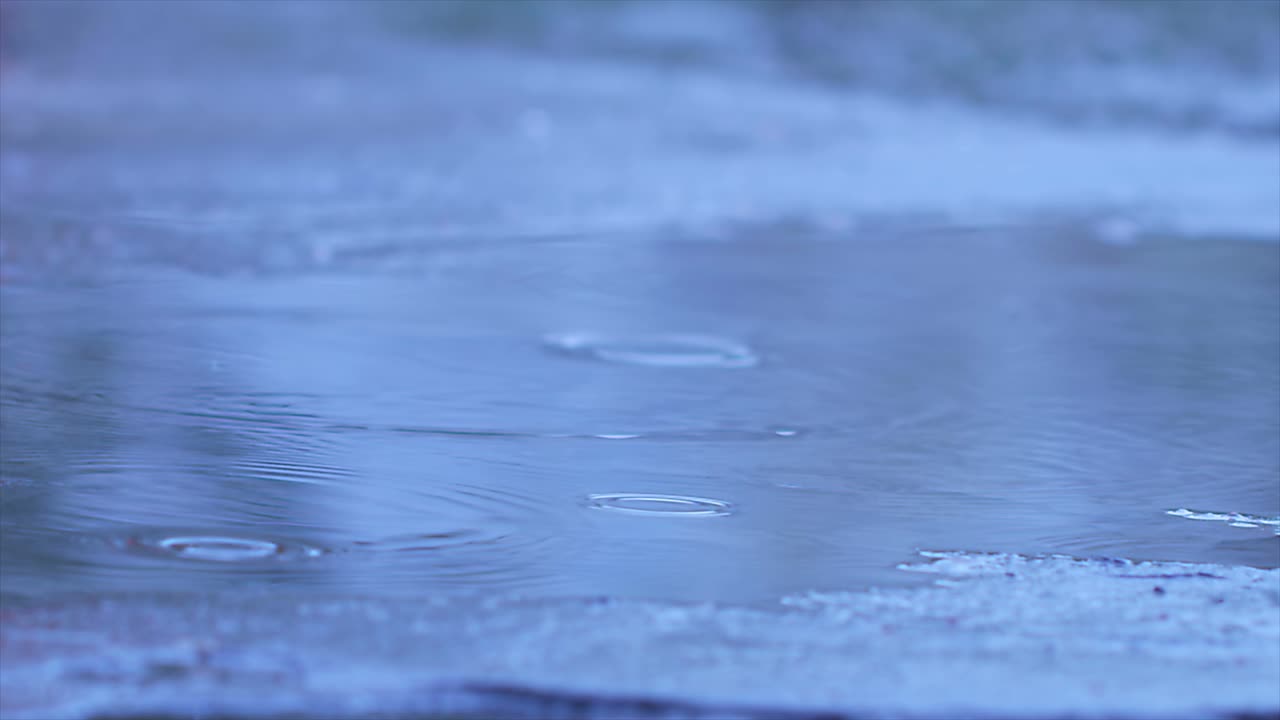 Rain Drops Falling To Asphalt