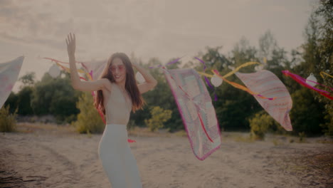 happy beautiful young female brunette dancing with arms raised