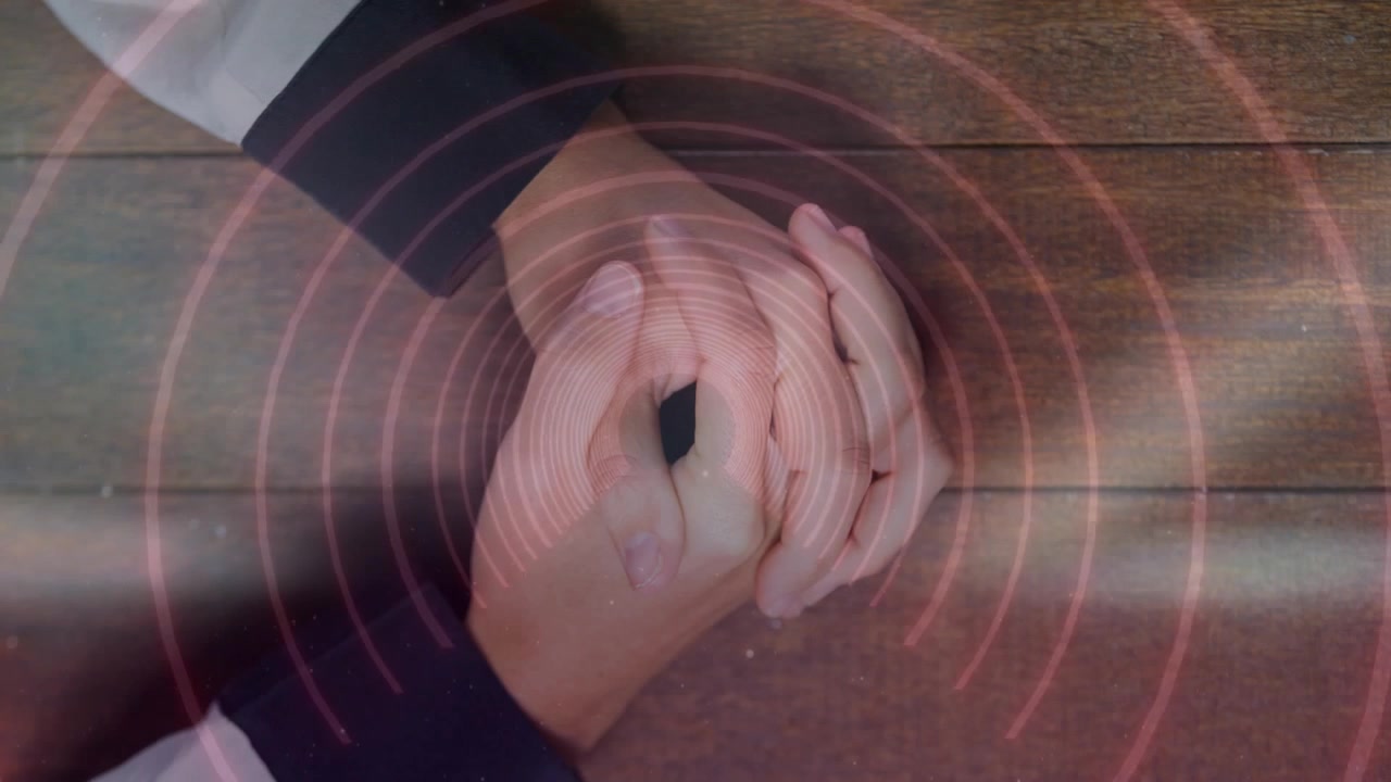 Pink rings appearing around clasped hands, pulsing outward while hands staying still, showing focus