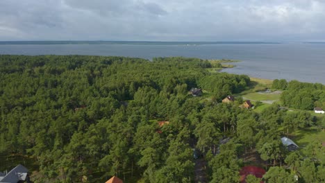 forward drone of an estonian village in the forest by the sea