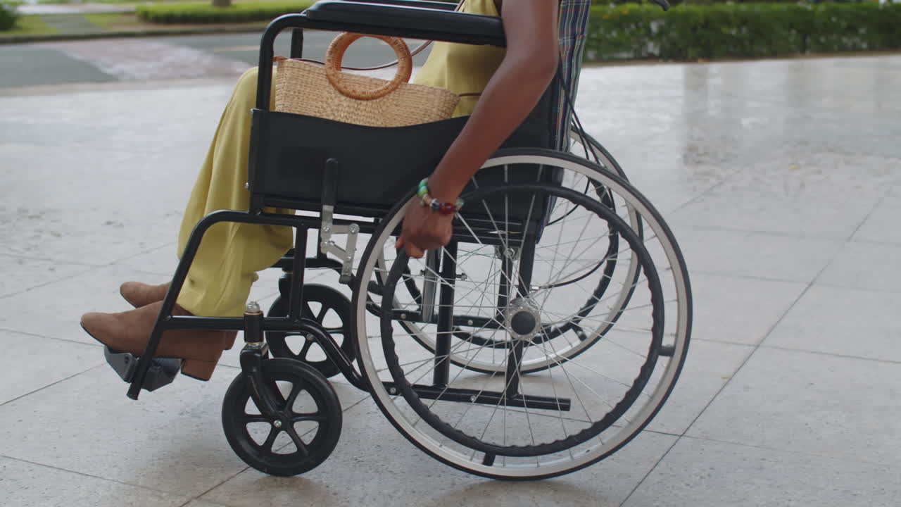 Unrecognizable Woman Moving in Wheelchair