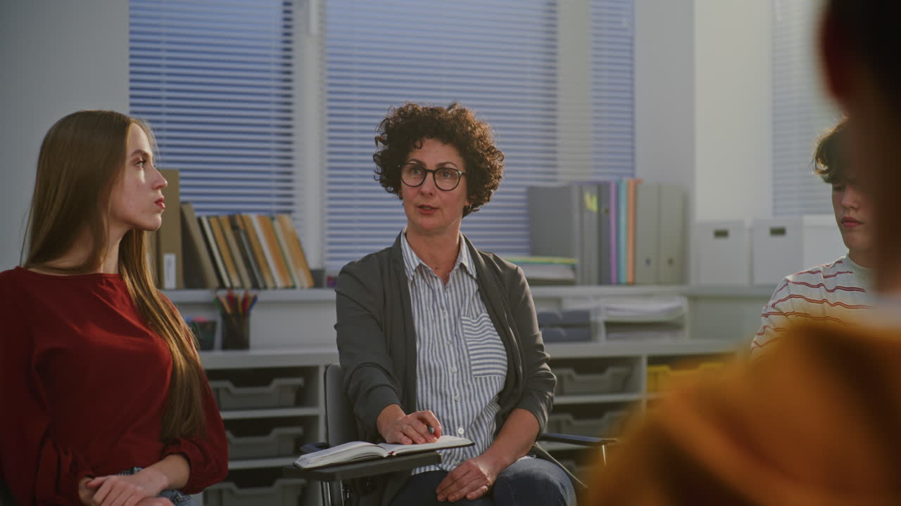 Group therapy session with a therapist and young people