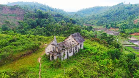 old church with broken roof in the middle of the green jungle