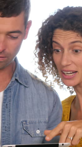 focused couple using tablet