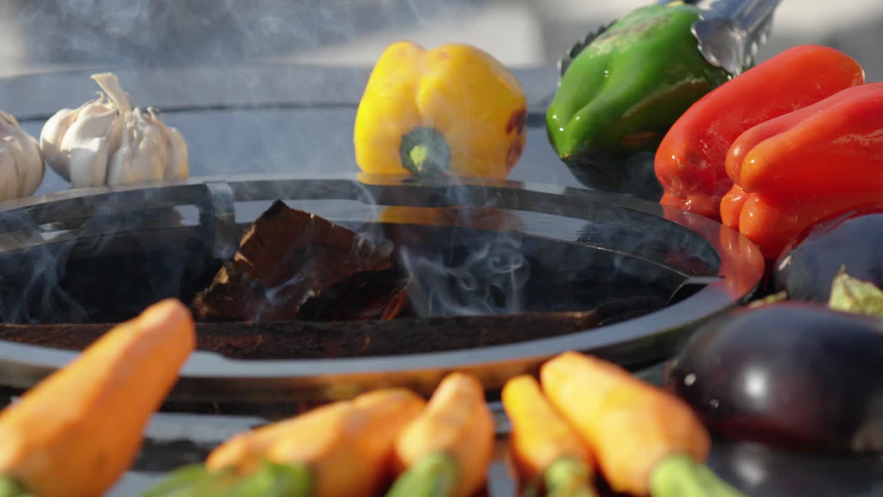 slowmotion of vegetables being flipped whilst cooking on a wood fire bbq