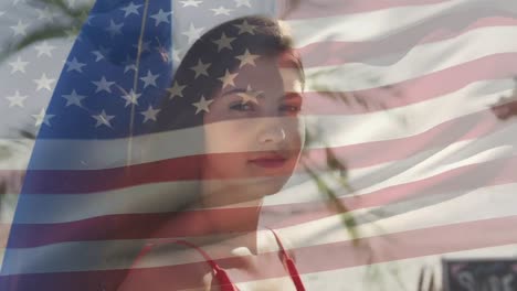 Animation-of-flag-of-usa-over-smiling-caucasian-woman-on-beach