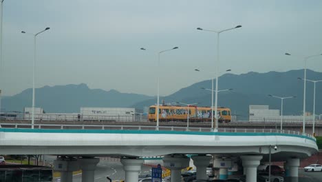 rail transit travelling by elevated railway at gimhae international airport in gangseo district, busan, south korea