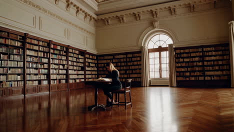 woman reading in a grand library