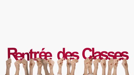 las manos sosteniendo rentree des clases