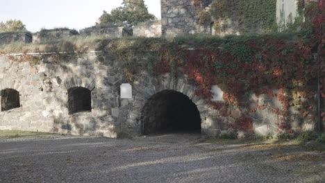 walking towards a passage to a medieval castle, a ancient fortress, on a cold autumn day, on suomenlinna military island, in helsinki, uusimaa, finland