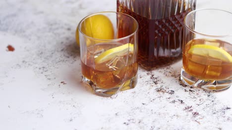 whiskey sour drink with lemon in glass on stone rustical background