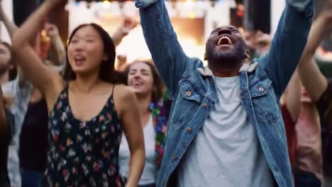 a joyful celebration of music and togetherness at an energetic concert, where fans unite to dance, cheer, and enjoy the vibrant atmosphere under colorful lights