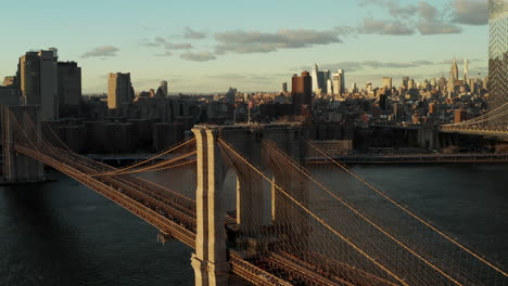 Heavy-traffic-on-Brooklyn-Bridge--lit-by-bright-sun.-Business-skyscrapers-in-background.-Manhattan,-New-York-City,-USA