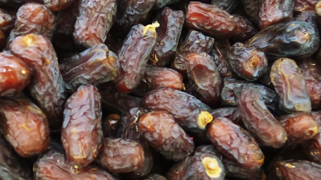 Date fruits or date palm. Heap of date fruits in a super shop smooth slide motion.Fresh healthy fruit.