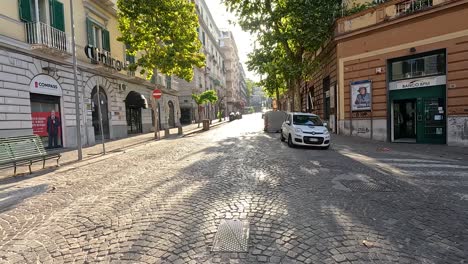 a car driving down a cobblestone street