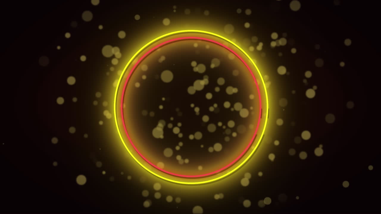 검은색 배경의 밝은 반점 위에 빨간색과 노란색 네온 반지의 애니메이션.