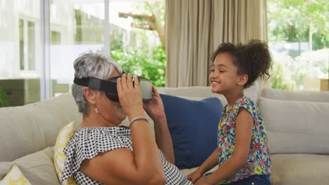 grandmother and granddaughter using virtual reality headset at home