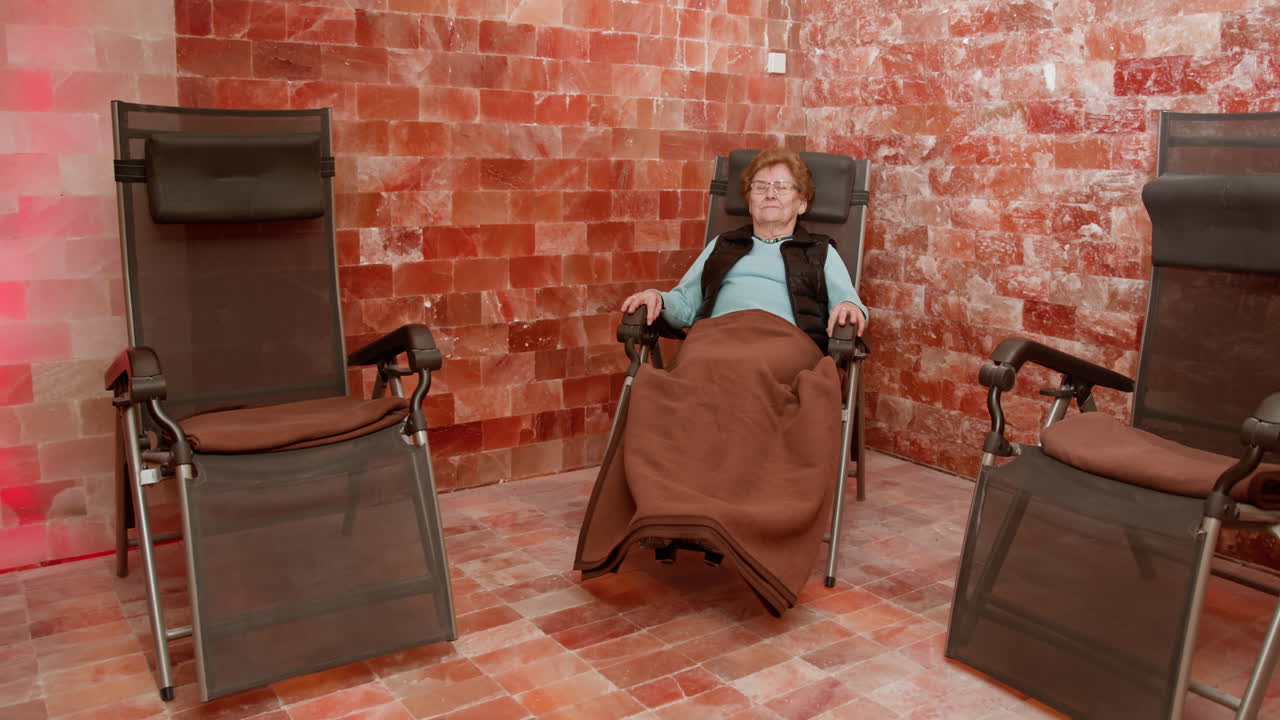 Elderly woman relaxing in a salt room