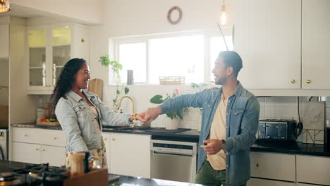 happy couple dancing in the kitchen