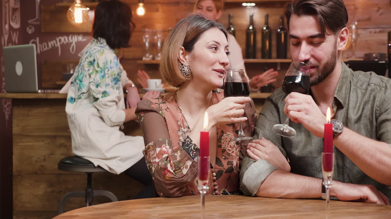 Couple enjoying a romantic date with wine at a bar