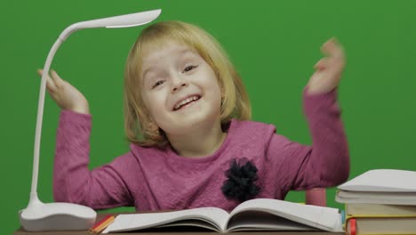 girl drawing at the table. education process in classroom. chroma key
