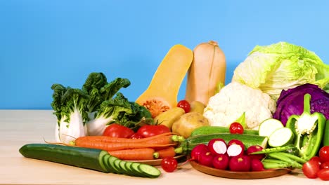 assorted vegetables arranged against a blue background