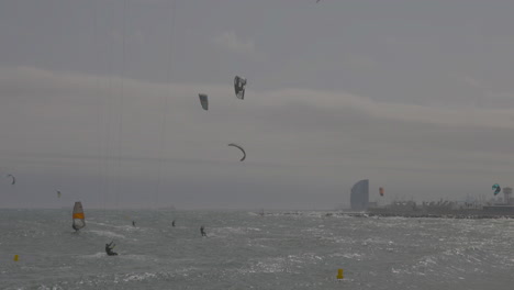 Kitesurfers on a windy day at sea in barcelona
