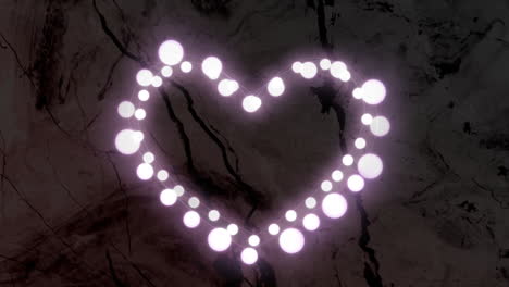 animación en forma de corazón de esferas blancas brillantes que pulsan sobre un fondo de textura oscura