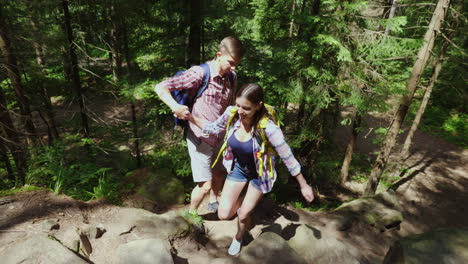 young attractive couple is walking in the forest hiking and active lifestyle