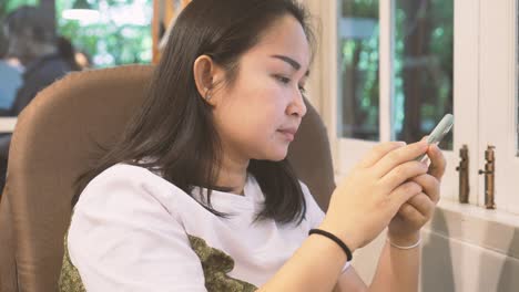 woman using smartphone in coffee cafe