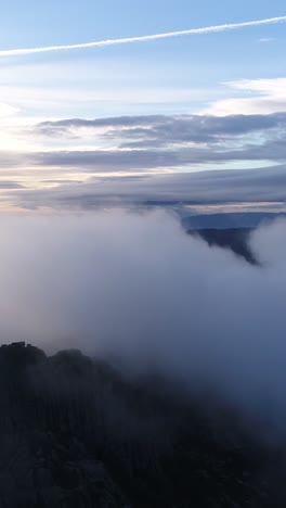 flying over clouds mountain landscape blue sky vertical video