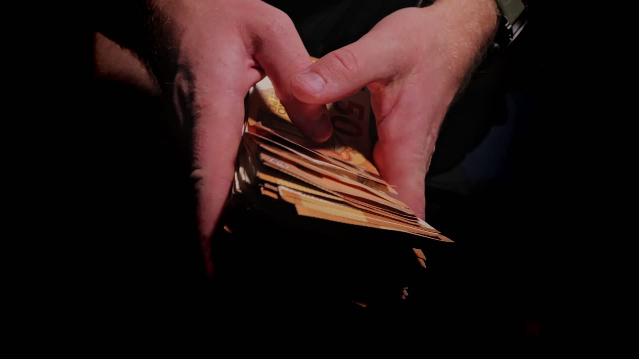 Euro Banknotes Counted, Against Black Background, Dark Finance, Wealth Metaphor