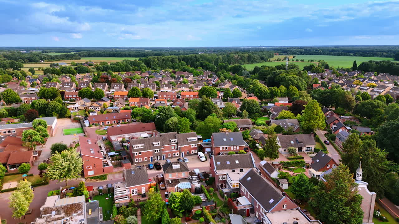 Aerial view of a peaceful village. Lush greenery surrounds charming homes in a peaceful village, showcasing the beauty of rural life during daylight hours
