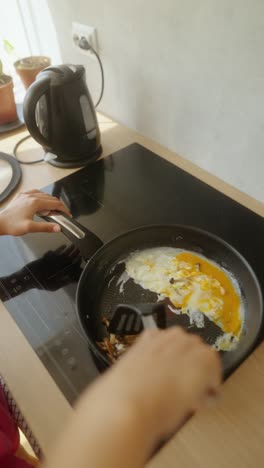 cooking breakfast eggs with mushrooms