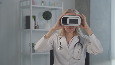 a blonde, middle aged female doctor tests vr glasses