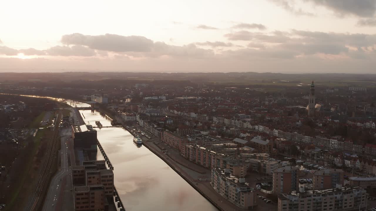 High angle shot of a historical city center with a canal next to ti. Aerial shot