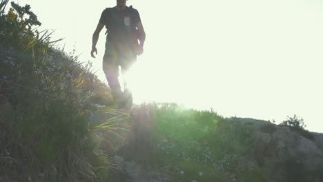 young man runs down steps towards camera golden hour slow motion