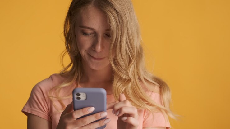 Caucasian woman scrolling on smartphone.