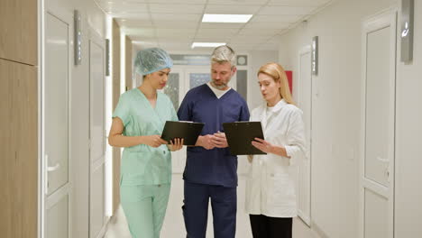 medical professionals discussing in hospital corridor