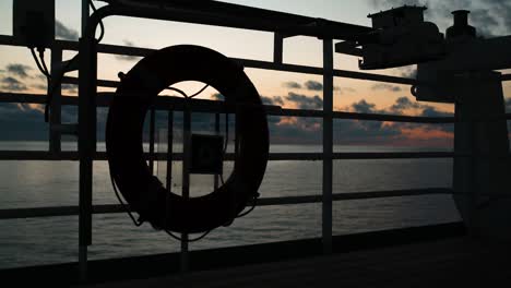 safety oversea insurance on board cruise ship emergency evening silhouette life saver lifebuoy lifering sunset beautiful ocean