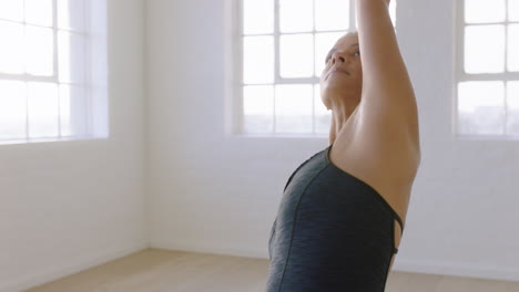 beautiful yoga woman practicing reverse warrior pose enjoying fitness lifestyle exercising in studio stretching flexible body training early morning meditation on exercise mat