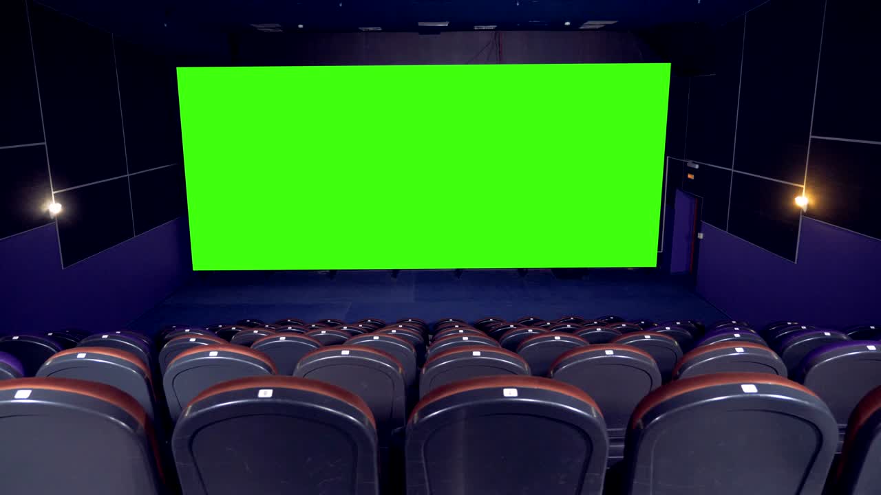 Cinema hall, cinema, movie hall. Big chroma key screen in the cinema hall.