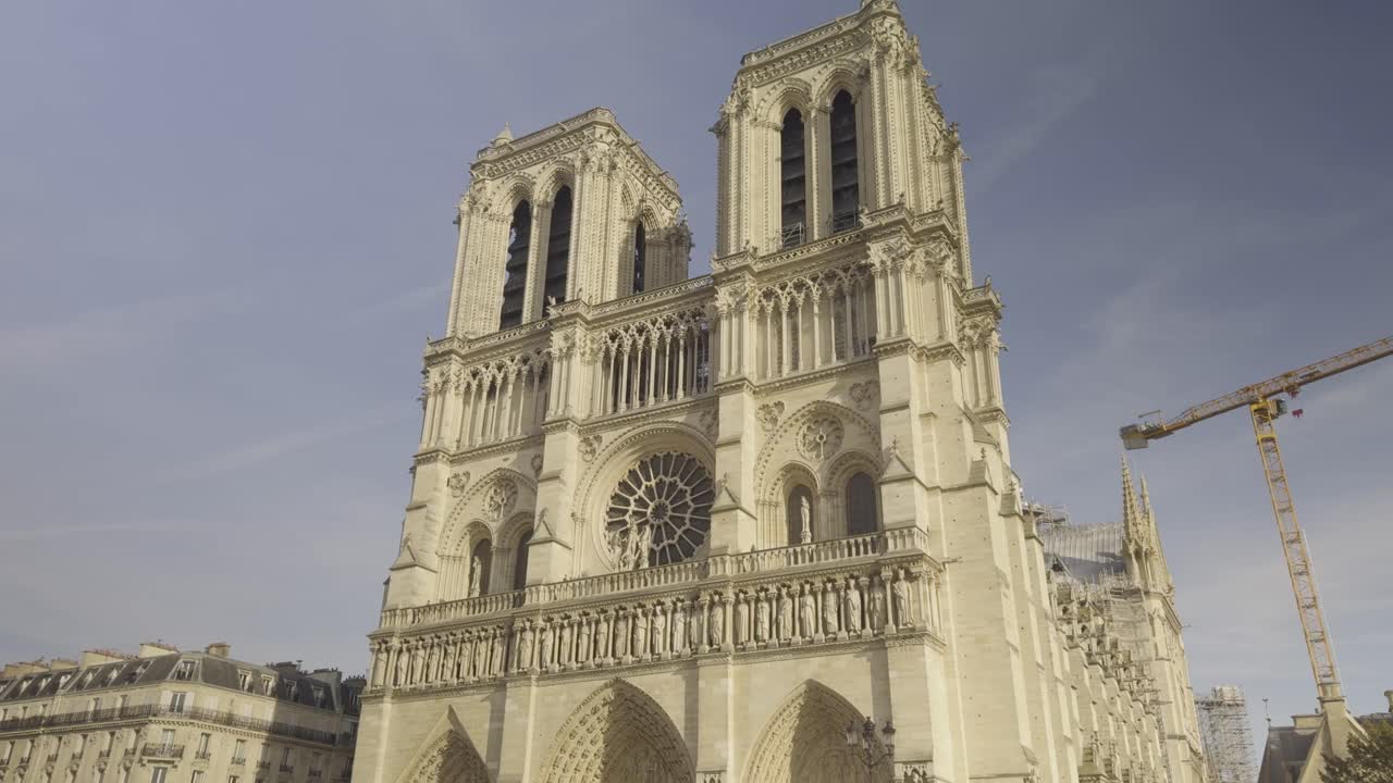 Facade of Notre-Dame de Paris after reconstruction, crane in background, Paris, France