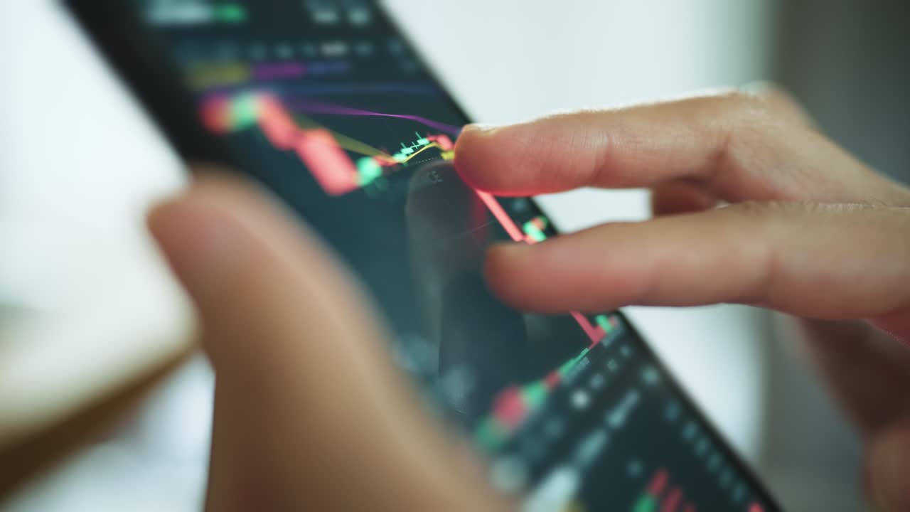 Woman is checking Bitcoin price chart on digital exchange on smartphone, cryptocurrency future price action prediction.